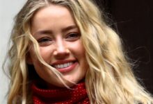 Actor Amber Heard reacts as she arrives at the High Court in London