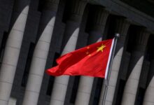 Chinese flag flutters in front of the Great Hall of the People in Beijing
